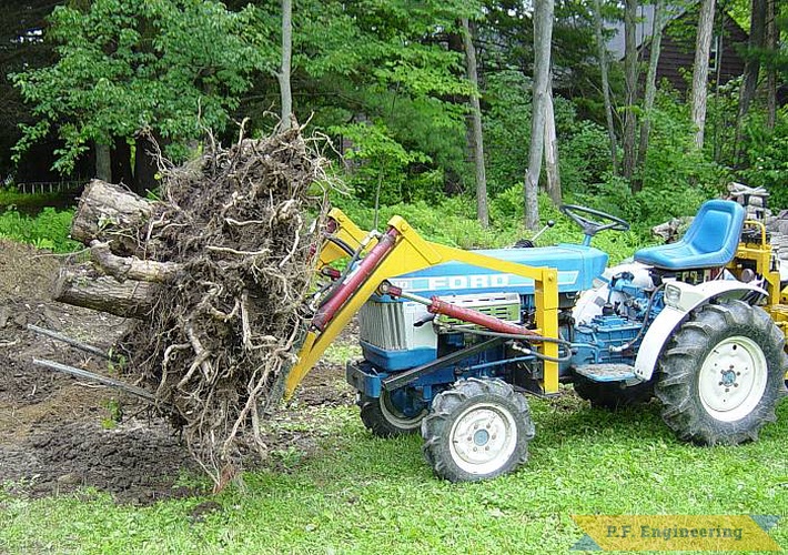some more pics of the P.F. Engineering prototype front end loader on the Ford 1110 compact Diesel 4WD tractor. seen here lifting a stump i dug out prior to building my new fabrication shop | Ford 1110 compact tractor loader_3