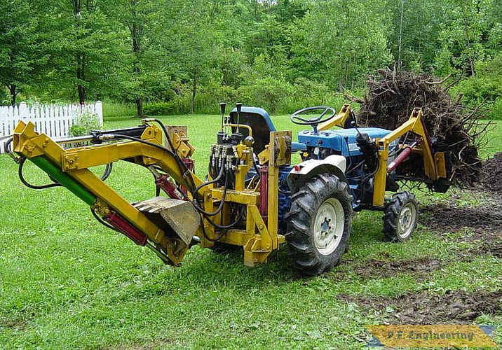 some more pics of the P.F. Engineering prototype front end loader on the Ford 1110 compact Diesel 4WD tractor. seen here lifting a stump i dug out prior to building my new fabrication shop | Ford 1110 compact tractor loader_4