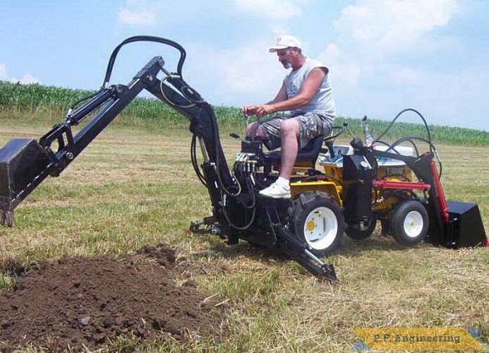 here is Mr. R. himself at the controls of the Micro Hoe. | Cub Cadet 125 garden tractor Micro Hoe_2